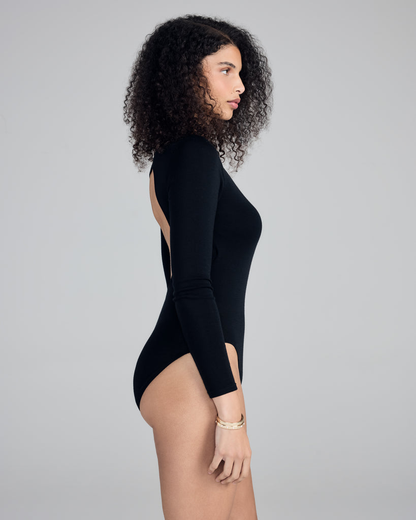 Aromatique's black wool bodysuit has a classic look from the front, with a bold round cutout at the back
