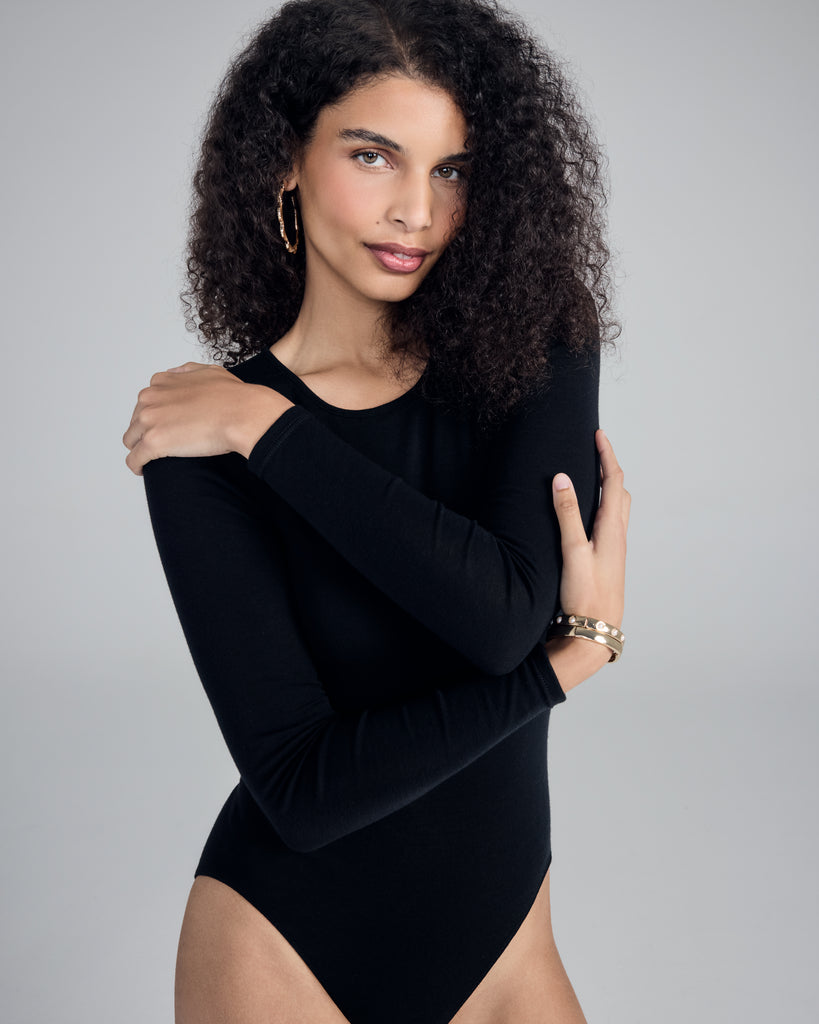 Unique long sleeved bodysuit by Aromatique is crafted from an ultra fine black ribbed wool