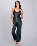 The Clara Moss silk pajama set from Emma Harris is crafted from a dark green silk with shimmering black floral lace appliqué