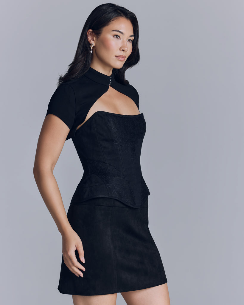 The Estelle bolero from Estelle Wiele closes at the high neck with two hand-crafted silver hook and eye closures