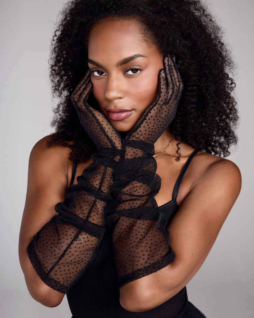 Opera length Eloise gloves from Karma are crafted from a transparent black tulle with polka-dot detailing