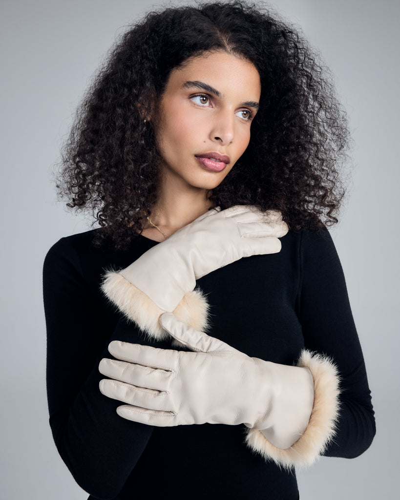 The Corina Ivory Gloves from Karma hit around mid forearm with the fur lining worn down, near the wrist with the fur lining reversed