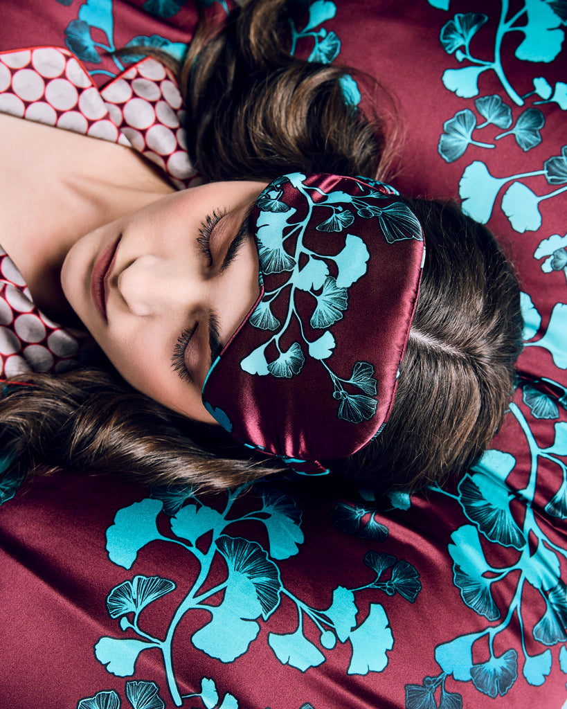 Silk pillowcases from Karma on the Rocks are crafted from an exquisite burgundy red silk charmeuse with a gingko print in shades of teal