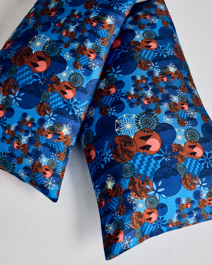 Silk pillowcases from Karma on the Rocks are crafted from a luxurious blue silk twill with a Japanese-inspired print showcasing clouds, suns, foliage and geometric designs in shades of blue, red, black and gold