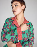 The classic button-down top on Karma's Isa Sayuri Jade pajama has a generous fit with a notched collar, orange piping, and contrast print at the collar, cuffs and hem