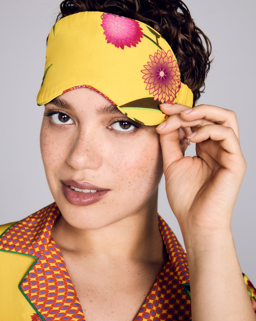 Luxurious Yuri Yellow silk sleep mask from Karma on the Rocks is crafted from a bright yellow silk twill with a pink and orange floral print