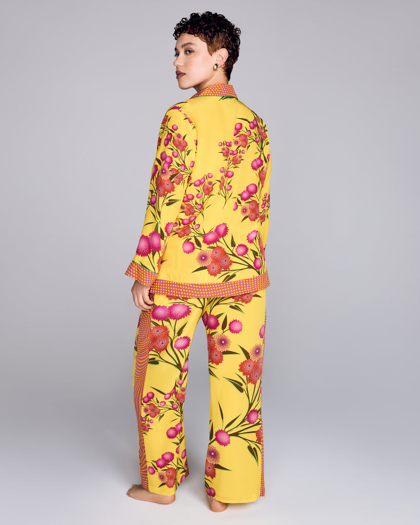 Karma's Isa Yuri Yellow silk pajama pant has a loose fit with a fully elasticized waist, pockets, and contrast print down the sides of the legs