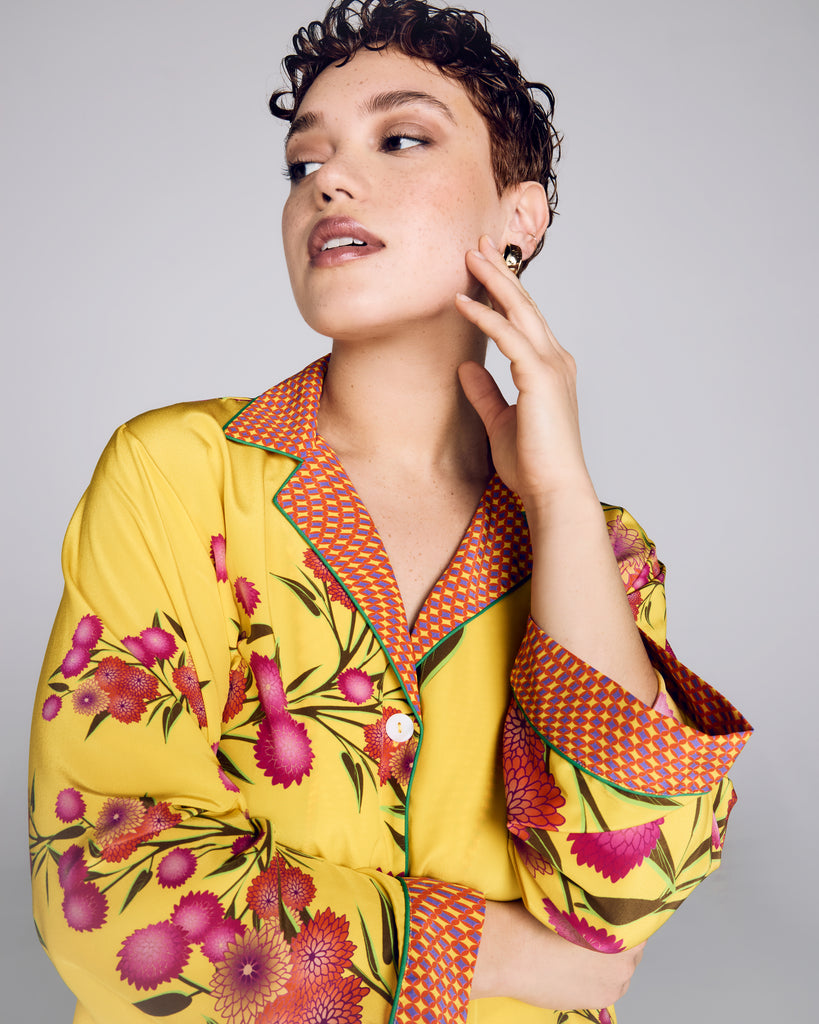 Exquisite Isa Yuri Yellow silk pajama from Karma on the Rocks is crafted from a bright yellow silk twill with a pink and orange floral print, with a contrasting psychedelic geometric print in shades of yellow, orange and purple