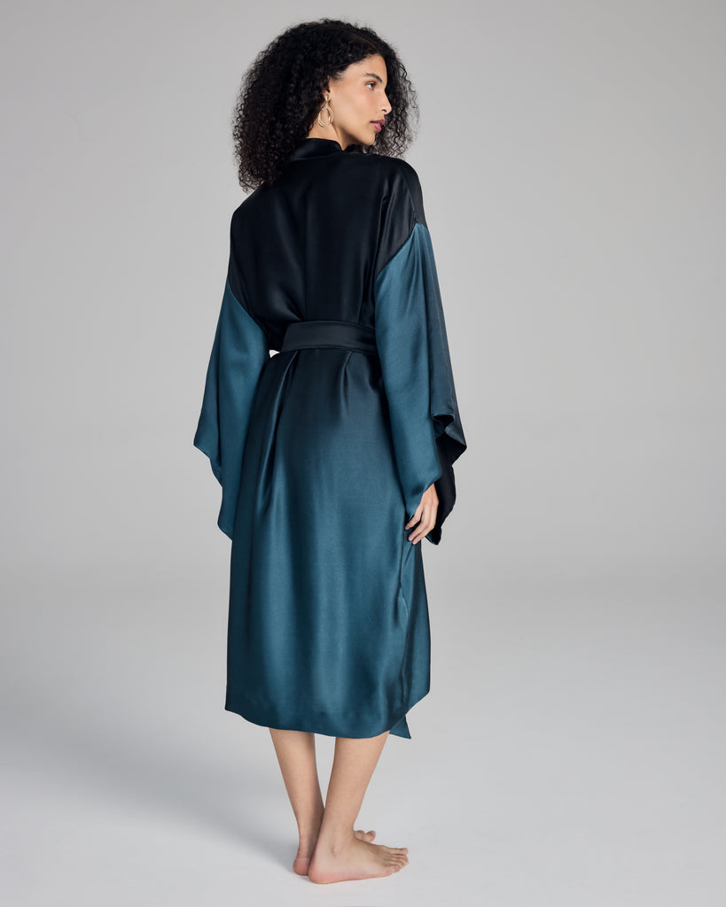 Exquisite kimono robe from Merle Noir is made from a spectacular degrade silk, shifting from the darkest black at the shoulders to a vibrant teal bleu at the hem