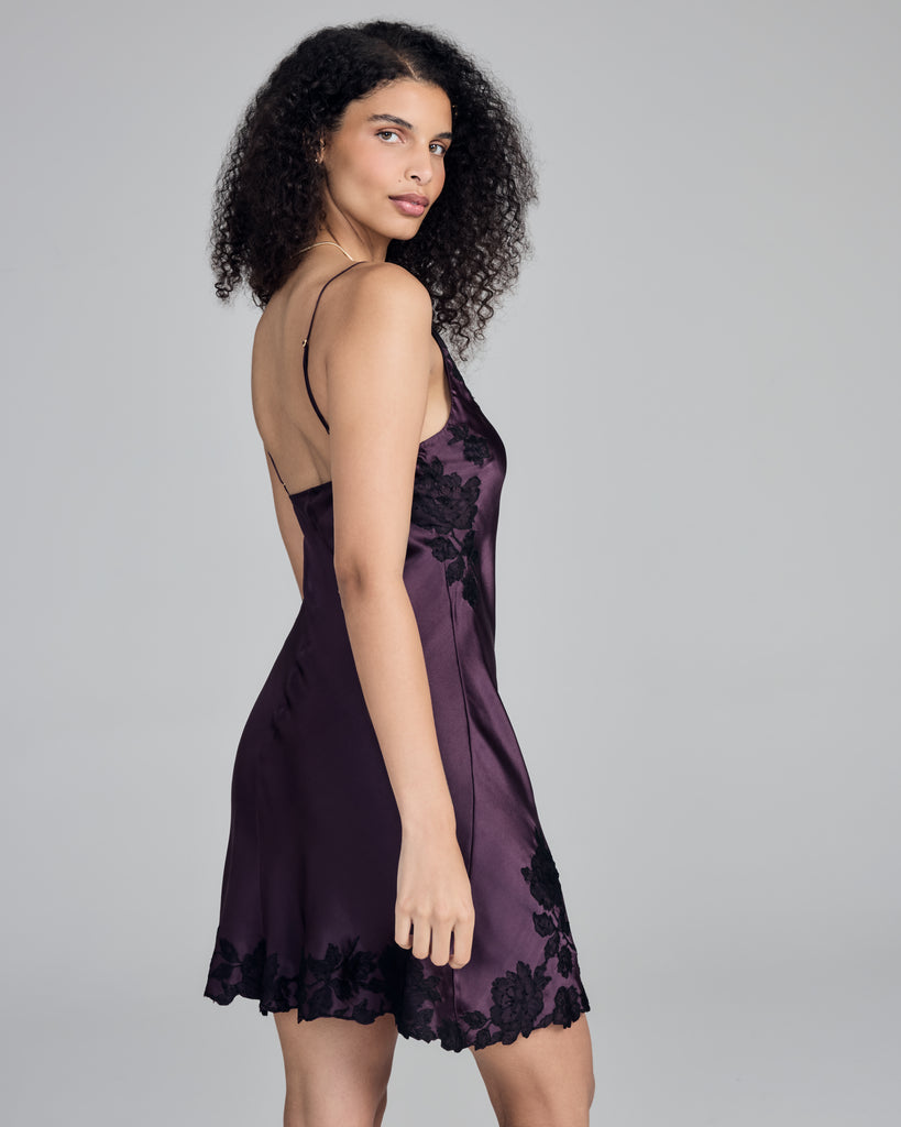 Rich purple chemise from Merle Noir showcases magnificent black floral lace appliqué at the neckline and hem