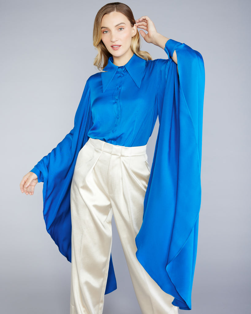 Incredibly dramatic kimono sleeve drops down nearly 40”, with a buttoned cuff at the wrist on the Cobalt Bat Sleeves Shirt from Stelios Koudounaris