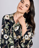 Classic Aphrodite pajama set from Temperley is crafted from black silk with a pattern of monkeys, parasols, leopards, pagodas, and flowers in shades of green and white