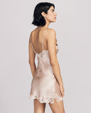 The Clara Vintage Rose chemise from Emma Harris hits at the upper thigh on most, with lace appliqué at the entire hemline