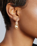 Dangling hoop earrings from Gisel B are crafted from 3 micron 24k gold plated sterling silver and 4mm round freshwater cultured pearls