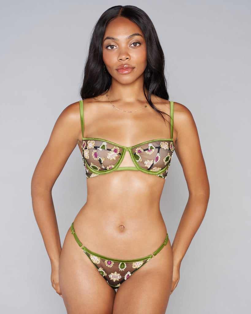 Luxurious Sofia lingerie set from Studio Pia is crafted from black tulle embroidered with jewels in shades of white, pink, green, gold, and mulberry with green silk accents and 24k gold plated hardware