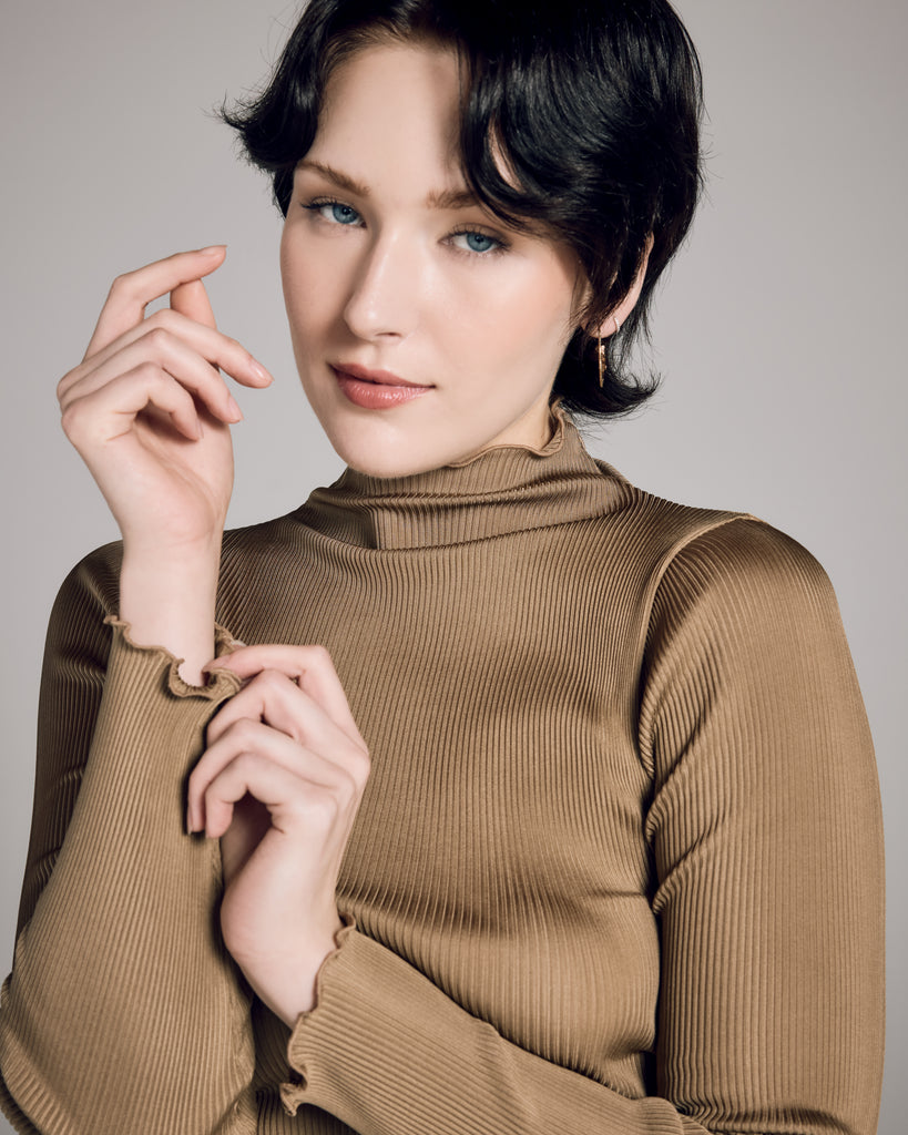 Luxe gold long-sleeved, mock-neck top from Aromatique is crafted from a ribbed 100% silk