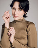 Luxe gold long-sleeved, mock-neck top from Aromatique is crafted from a ribbed 100% silk