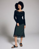 Boglietti's Brianna black long sleeve is crafted from a ribbed knit silk wool blend with floral detailing at the boat neckline
