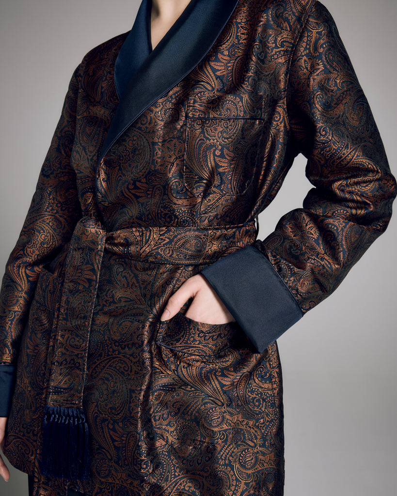 The Verona smoking jacket from Derek Rose is crafted from an Italian silk Jacquard with a navy background and paisley pattern in shades of gold and black