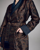The Verona smoking jacket from Derek Rose is crafted from an Italian silk Jacquard with a navy background and paisley pattern in shades of gold and black