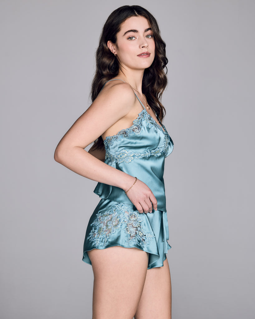 Astri silk camisole and tap pant from Emma Harris are crafted from a gorgeous cloud blue silk with tonal blue and green floral lace appliqué&nbsp;