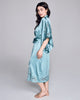 Sublime Astri silk robe from Emma Harris is crafted from a vibrant blue silk with tonal blue and green floral lace appliqué