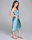 Luxurious Astri slip dress from Emma Harris is crafted from vibrant blue silk with tonal blue and green floral lace appliqué 