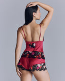 The Kalea camisole and short set from Emma Harris is crafted of red silk with embellished black lace appliqué 