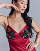 Striking Kalea slip from Emma Harris is crafted from red silk and an exquisite black lace with green leaf embroidery and textural silk appliquéd to look like flowers in shades of red, toffee, purple and pink