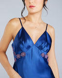 The Veronique silk camisole has adjustable spaghetti straps and pleated cups for fit, with lace appliqué as falling flowers under the bust down the sides