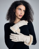 The Corina Ivory Gloves from Karma hit around mid forearm with the fur lining worn down, near the wrist with the fur lining reversed