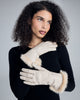 The Corina Ivory Gloves from Karma hit around mid forearm with the fur lining worn down, near the wrist with the fur lining reversed
