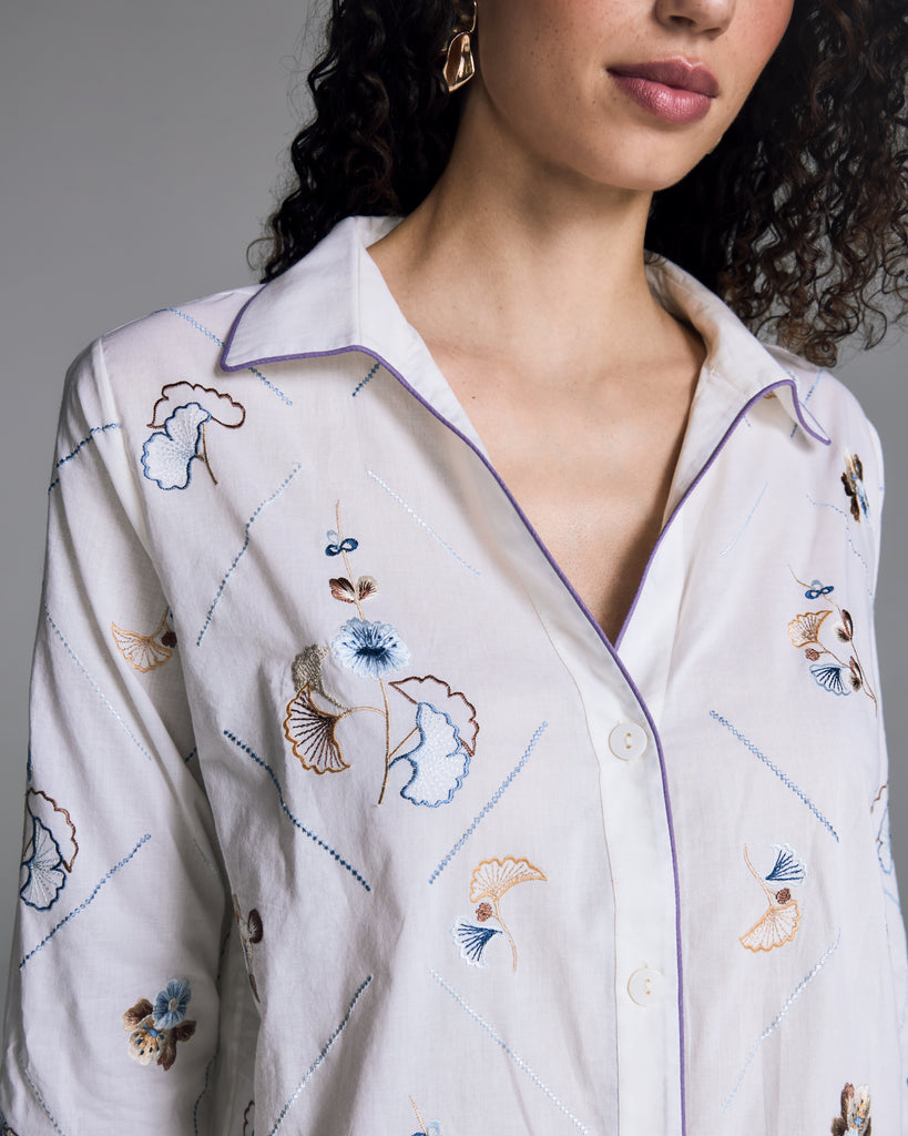 Elegant white Tokyo pajama from Karma on the Rocks is crafted from a whisper-weight cotton cambric with geometric floral and gingko leaf embroidery in shades of brown, blue and gold