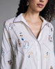 Elegant white Tokyo pajama from Karma on the Rocks is crafted from a whisper-weight cotton cambric with geometric floral and gingko leaf embroidery in shades of brown, blue and gold