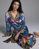 Long-sleeved Kami shirtdress robe from Karma on the Rocks is crafted from a vibrant sapphire silk with patterning in shades of orange, pink, red, and olive green