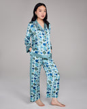 The classic button-down top on the Chochin Aqua Isa pajama from Karma on the Rocks has a generous fit with a notched collar, coral piping, and contrast print at the collar, cuffs and hem