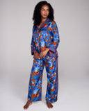 Exquisite Tama Blue silk pajama from Karma on the Rocks is crafted from a luxurious blue silk twill with a Japanese-inspired print showcasing clouds, suns, foliage and geometric designs in shades of blue, red, black and gold 