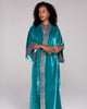 Full length Nikko robe from Karma on the Rocks is crafted from a decadent teal blue silk velvet with a geometric embroidery in shades of coral, navy and gold at the shawl collar and cuffs