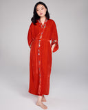 Full length robe from Karma on the Rocks is crafted from a vibrant red silk velvet with a teardrop embroidery in shades of gold, silver and purple at the shawl collar, cuffs, and back