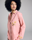Karma's Tokyo Cottin Pajama has a tailored button-down top with mother of pearl buttons, white piping, and yellow floral embroidery at the collar, cuffs, and pocket