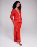 The Tokyo red velvet pajama from Karma on the Rocks has a  tailored red velvet button down top with the geometric embroidery at the v neckline and narrow collar, white piping, and mother of pearl buttons