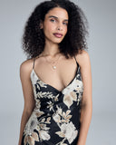Ankle-length wrap dress from Merle Noir is crafted from a black silk with a Valentino white and gold floral print at the top