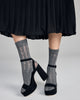 Cozy knee-high  Carolyn sock from Pierre Mantoux is crafted in an open knit with sinuous floral lines