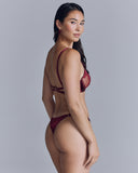 Seraphina Ruby thong from Seelanii is crafted from sheer tulle with lace appliqué, adjustable side straps, and a silk rear and gusset