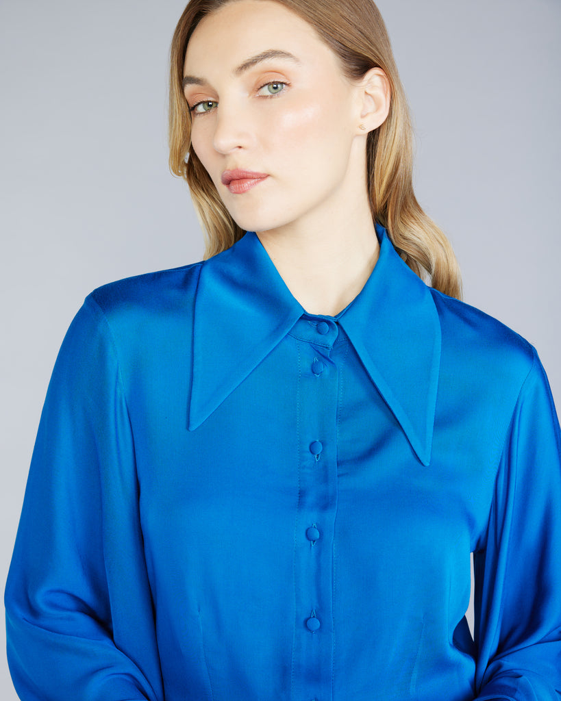 The Stelios Koudounaris Cobalt Bat Sleeves Blouse is fitted through the body with a button-down front and dramatic oversized pointed collar