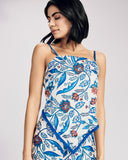 Lightweight silk Santorini top and trouser set from Emma Ducci showcases a floral pattern in shades of blue, red, and black on a crisp white background