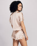 The Emma Harris Clara Vintage Rose Bed Jacket has a semi-cropped fit with dolman sleeves and a silk tie closure at the neckline