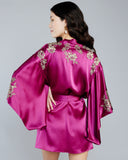 Exquisite gold leavers lace appliqué on the Celeste Raspberry silk kimono robe from Emma Harris