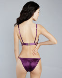 Eos low-rise panty from Karolina Laskowska has a lace front, silk gusset, ruched silk rear, and coordinating silk bows with crystal drops on each hip