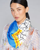 Balabar scarf from Ika Paris has a modern abstract design in shades of black, white, blue, yellow and red